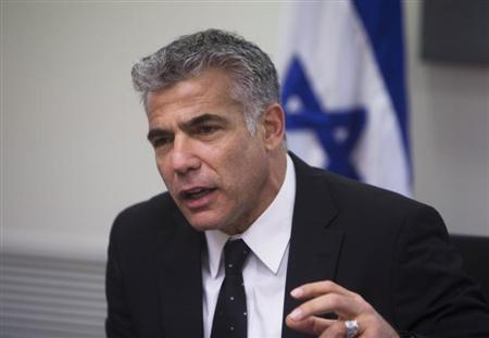 Lapid speaks during a Yesh Atid party meeting, at the Knesset, the Israeli parliament, in Jerusalem
