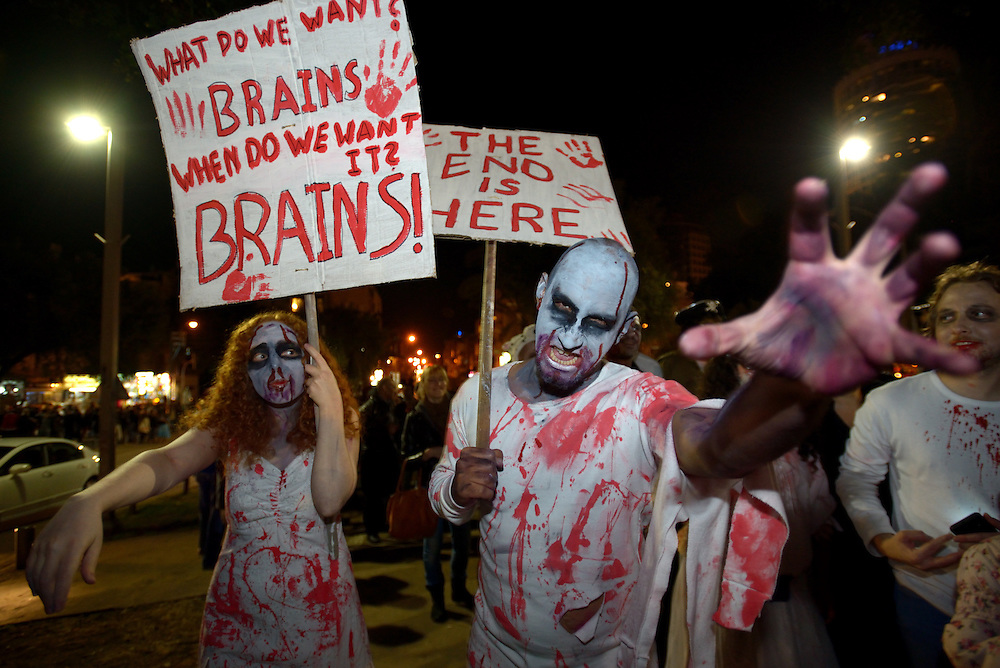 Israelis wearing zombie make-up and costumes participate the Zombie Walk during the Purim festival in Tel Aviv