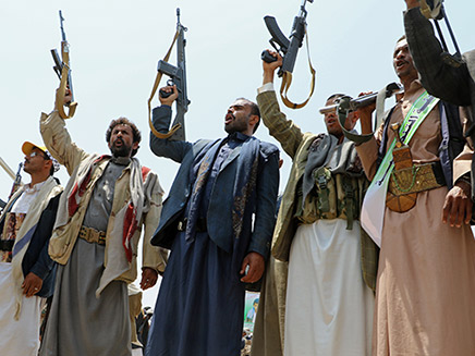 Mourners hold up their rifles as they attend a funeral of people, mainly children, killed in a Saudi-led coalition air strike on a bus in northern Yemen, in Saada