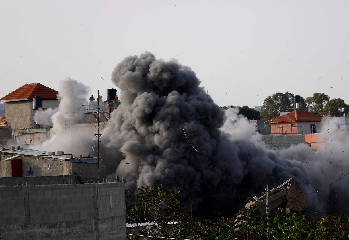 Smoke rises as Israeli forces blow up the family house of Palestinian assailant Omar Abu Laila, in Az-Zawiya village, in the Israeli-occupied West Bank