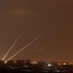 Streaks of light are pictured as rockets are launched from the northern Gaza Strip towards Israel, as seen from Sderot