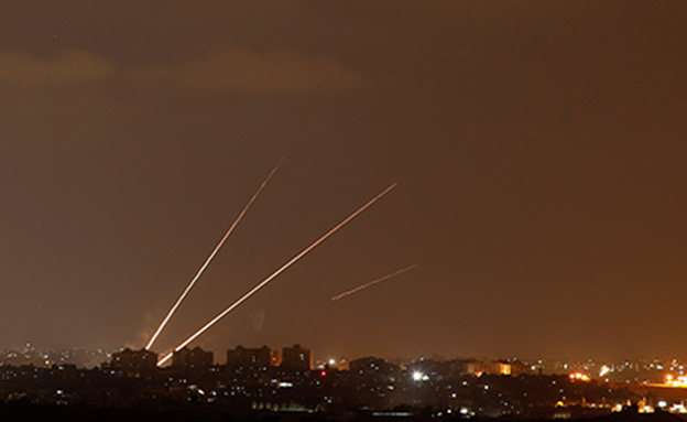 Streaks of light are pictured as rockets are launched from the northern Gaza Strip towards Israel, as seen from Sderot