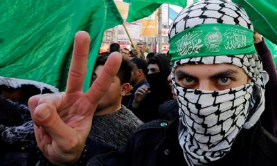 Palestinian Hamas supporter gestures during a rally marking the 31st anniversary of Hamas’ founding, in Nablus in the Israeli-occupied West Bank