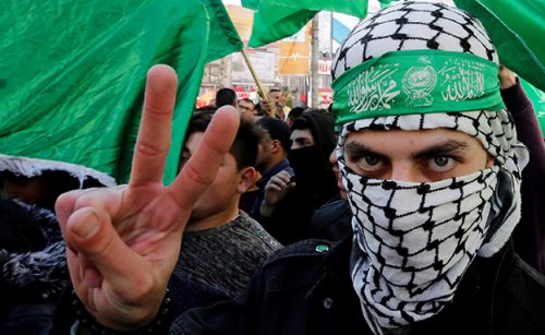Palestinian Hamas supporter gestures during a rally marking the 31st anniversary of Hamas’ founding, in Nablus in the Israeli-occupied West Bank
