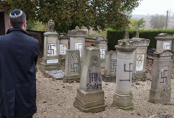 A member of the Jewish community inspects tombstones desecrated by vandals in a cemetery in Brumath …