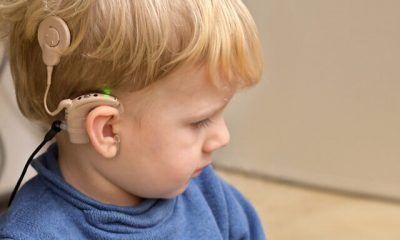 A Boy With A Hearing Aids And Cochlear Implants