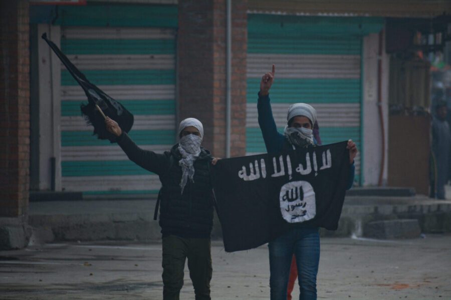 Kashmiri,Masked,Protester,Waving,Flags,During,Clashes,In,Nowhattah,Srinagar
