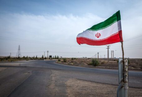 Iranian,Flag,On,The,Road,Next,To,Maranjab,Desert,In