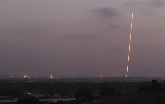 Light streak trail is seen as a rocket is launched from the northern Gaza Strip towards Israel