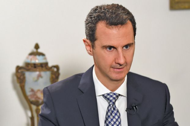 Syria’s President Bashar al-Assad attends an interview with Spanish newspaper El Pais in Damascus