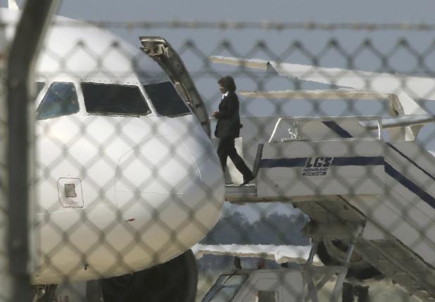 An official boards a hijacked EgyptairA320 Airbus at Larnaca Airport